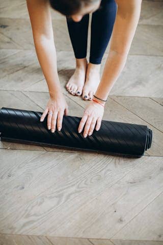 Photo by Elina Fairytale Woman Preparing Her Yoga Mat